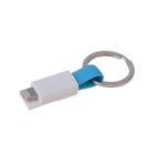 A compact white and blue keychain charger with a metallic ring. The charger features a USB connector and a lightning connector, designed for easy portability and convenience.