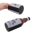 A hand holds a gray bottle cooler with black grip details, featuring a colorful logo. Below, an identical cooler wraps around a brown glass bottle. The cooler has a strap-like design with visible stitching.