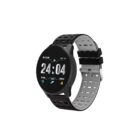 Smartwatch with a round black face displaying time and date. Features icons for heart rate, steps, and calories. The band is black with a gray underside and has small perforations.