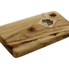 A rectangular wooden cutting board with a smooth surface and visible grain patterns. It has a hole in one corner with a tag attached. The tag displays text and an outline of a map.