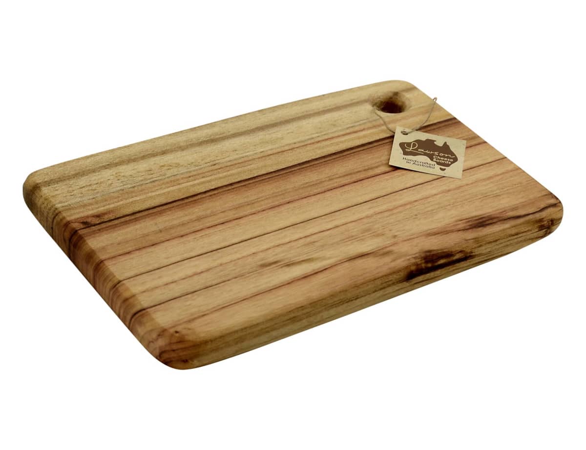 A rectangular wooden cutting board with a smooth finish and natural grain patterns. It has a small hole near one corner for hanging and a tag attached.