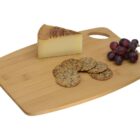 A wooden cutting board with a wedge of cheese, a small bunch of red grapes, and a cluster of round multigrain crackers arranged on it.