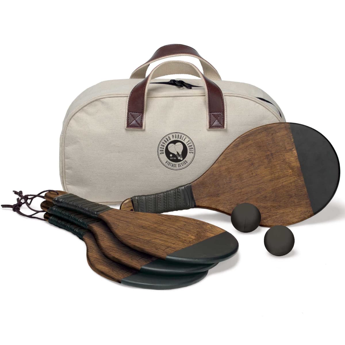 A set of four wooden paddles with green accents and two black balls are placed next to a cream-colored canvas bag with brown handles. The bag features a logo with two paddles and the text Paddle & Paddock Club and Esther Group.