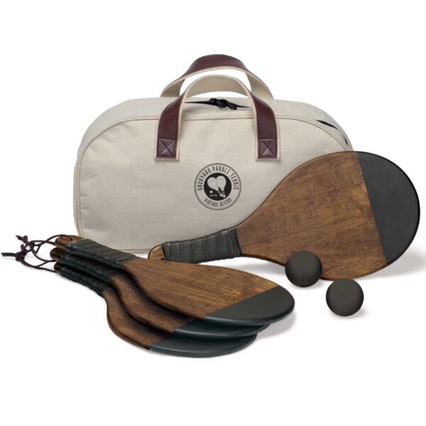 A set of wooden paddles with black grips and two black balls are displayed in front of a beige carry bag with leather handles. The bag has a round logo that reads Product of Italy with a stylized paddle and ball design.