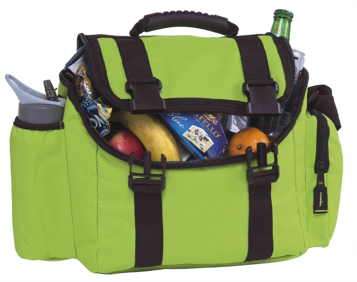A green insulated lunch bag with black straps is open, revealing a variety of items inside. Visible contents include a water bottle, a banana, an apple, an orange, a chocolate bar, and a beverage bottle.