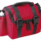 A red and black zippered bag with multiple compartments and a sturdy handle. It features side pockets, including one holding a white bottle. Black straps with buckles secure the main compartment.