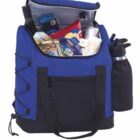 A blue and black cooler bag filled with various snack packages, a bottle, and a thermos. The bag features a front pocket, carrying handles, and side pockets.