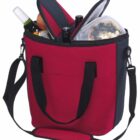 A red and black insulated tote bag filled with items, including a wine bottle, drink bottle, plastic food container, apple, and a folded umbrella. The bag has black handles and an adjustable shoulder strap.