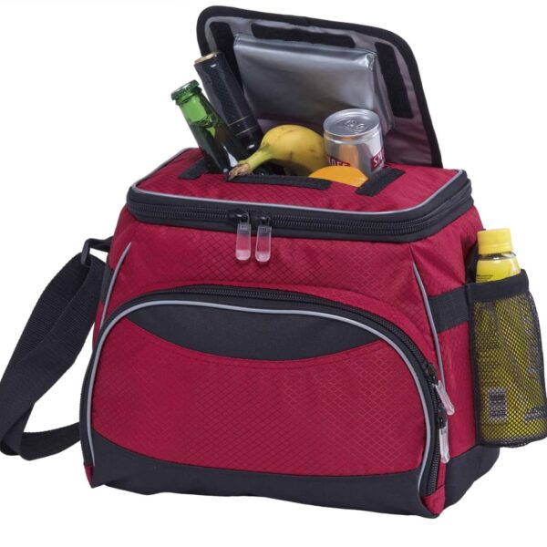 A red insulated cooler bag with a black strap and trim, open to show beverages, a banana, and other snacks inside. One side pocket holds a yellow bottle. The top flap is unzipped, revealing a silver lining.