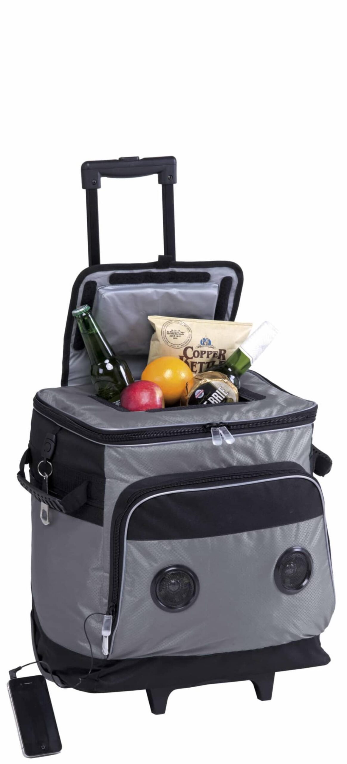 A gray rolling cooler with speakers in the front compartment. The coolers lid is open, revealing drinks, a bag of chips, an apple, an orange, and a water bottle inside. It is on wheels and has a retractable handle. A smartphone is connected to it.