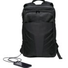 A black backpack with multiple compartments is shown. It features a textured front panel and a built-in charging port, with a phone connected via a cable. The backpack is placed upright against a plain white background.