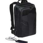 A sleek black backpack with a modern design, featuring padded straps and multiple compartments. A smartphone is connected to a visible charging cable, indicating the bags built-in charging capability.