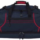 A large navy blue duffel bag with red accents, black handles, and multiple zipper compartments is displayed. The bag has a reinforced handle with a red grip padding on top.
