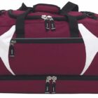 A maroon duffel bag with black handles and zippers, featuring white geometric accents on the sides.