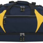 A large navy blue duffle bag with yellow accents, featuring multiple zippered compartments and black handles.