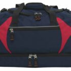 A large navy blue duffel bag with red accents and multiple compartments. It has black handles and zippers, with a spacious design suitable for travel or sports.