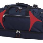 A navy blue duffel bag with red accents and multiple zippered compartments is shown. It has black handles and adjustable shoulder straps.