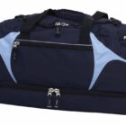 A navy and light blue duffel bag with black handles and multiple zippered compartments is shown. The bag features a two-tone design with side pockets and a separate bottom section, indicating spacious storage options.