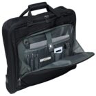 Black travel bag with an open front compartment revealing various items stored inside, including a tablet, pens, a phone, and a passport. The interior is gray with organized pockets for easy access. The bag has a top handle for carrying.