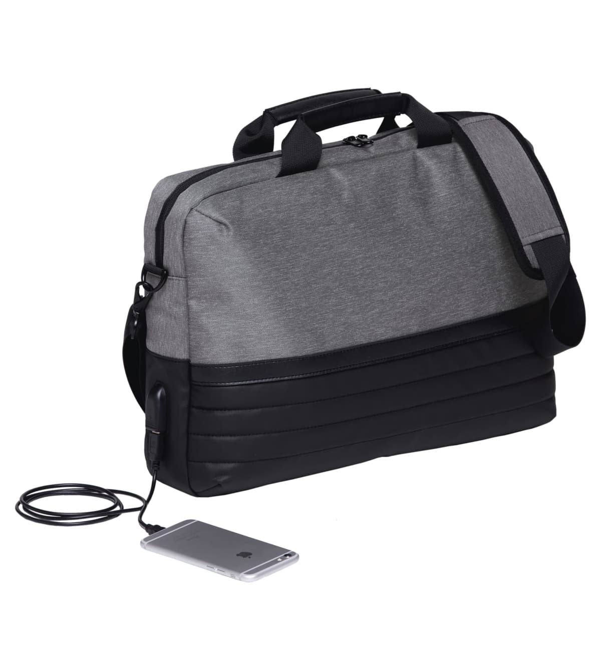 A two-tone gray and black messenger bag with a shoulder strap. It features a built-in USB charging port, connected to a smartphone with a cable. The bag is upright against a plain white background.