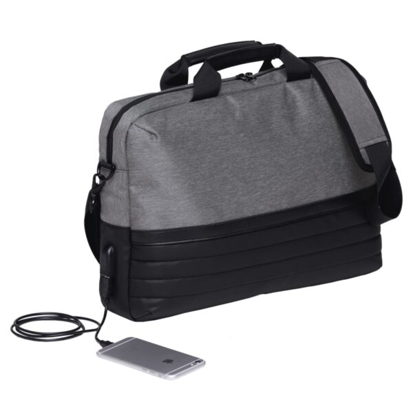 A gray and black messenger bag with a shoulder strap is shown. A smartphone is connected to the bag via a charging cable, indicating built-in charging capability. The bag features multiple compartments.