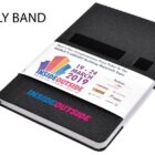 Black notebook with a promotional belly band for Inside Outside building materials expo, dated March 19-24, 2019. Features logos of various sponsors and partners on the band.