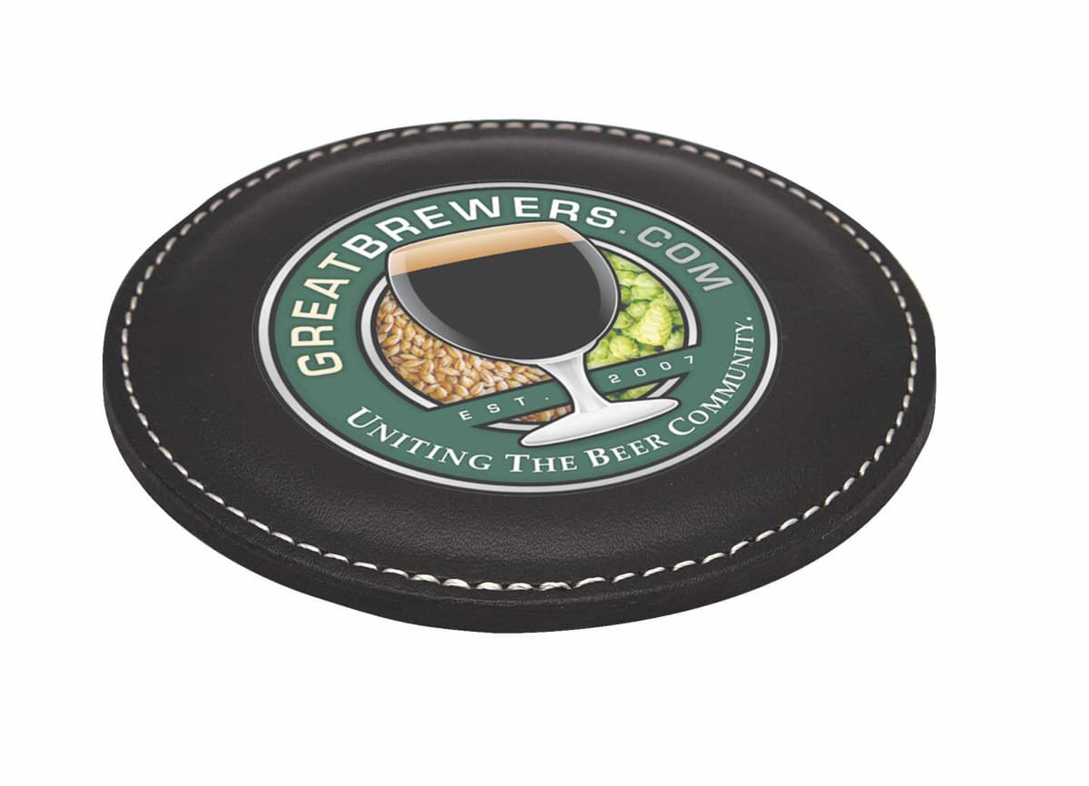 A circular black coaster with a logo depicting a glass of beer partially filled with hops and grains. The text reads GreatBrewers.com - Uniting the Beer Community - Est. 2007.
