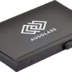 A sleek, black slim wallet with the Ausglass logo on the front. Its design includes a secure closure mechanism, with a minimalist and modern appearance.