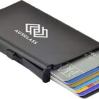 A slim, black metallic cardholder labeled AUSGLASS is partially open, displaying several credit cards in different colors neatly stacked inside.