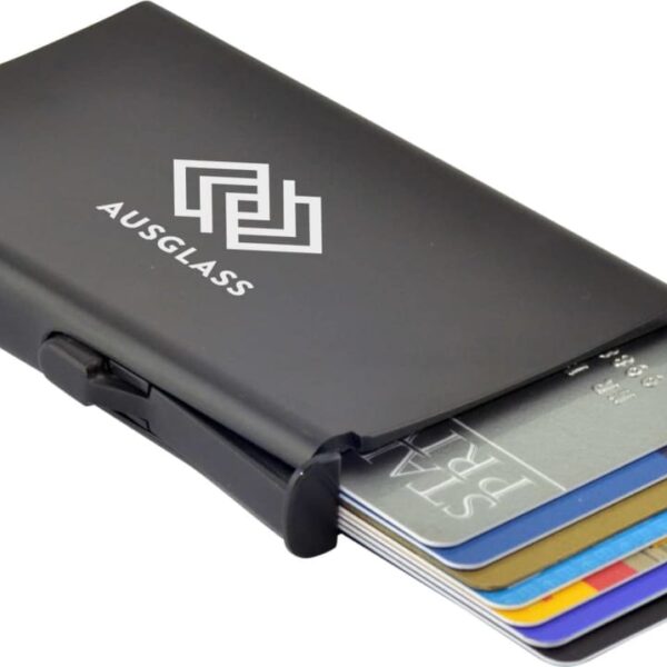 A slim, black metallic cardholder labeled AUSGLASS is partially open, displaying several credit cards in different colors neatly stacked inside.