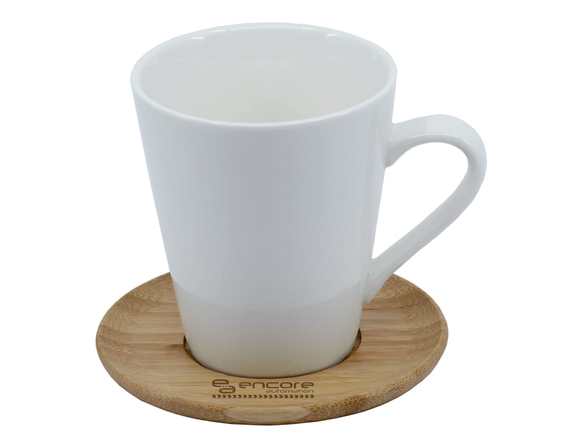 A tall white ceramic mug on a circular wooden coaster with the word encore engraved on it. The mug has a sleek handle, and the coaster features a simple, natural wood grain design.