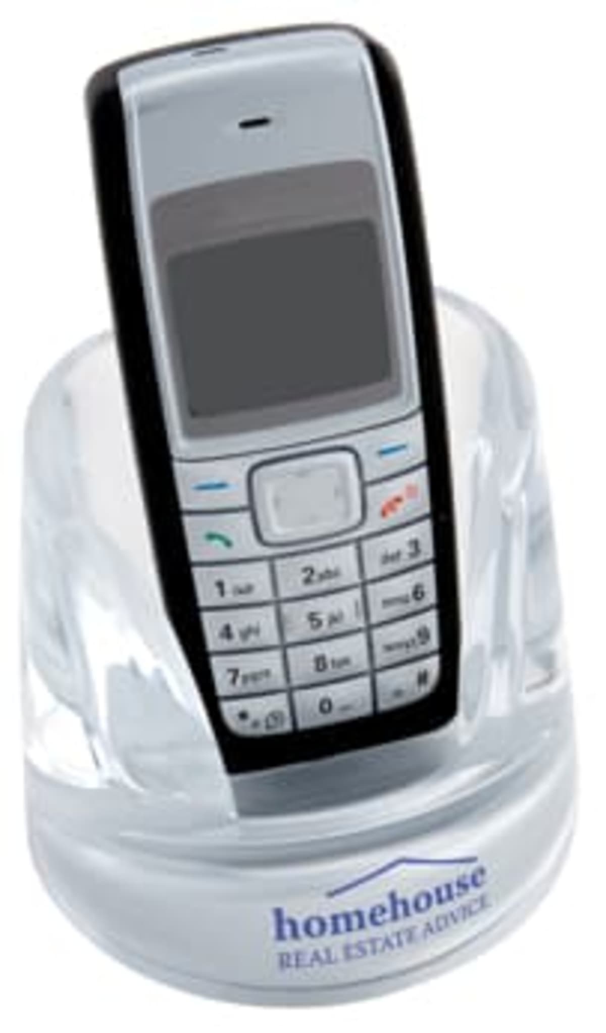A classic mobile phone with a keypad in a transparent stand. The stand has homehouse REAL ESTATE ADVICE printed on it.