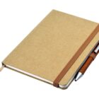 A closed brown notebook with an elastic band, featuring a pen attached to the side. The notebook has a ribbon bookmark peeking out. Its positioned at a slight angle on a white background.