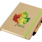 A closed notebook with a brown cover featuring a colorful leaf design and the words The Food Supply Co. It has a green elastic band and a pen attached to its side.