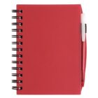 Red spiral notebook with a pen attached on the right side. The cover is solid red, and the metal spiral binding is on the left. The pen is partly visible and appears to be red with a white clip.