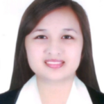 Meet the team: A smiling person in a white shirt and dark blazer against a plain backdrop.