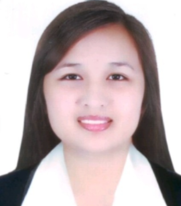 Meet the team: A smiling person in a white shirt and dark blazer against a plain backdrop.
