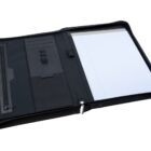 An open black leather portfolio with a lined notepad on the right, various pockets, and a zippered compartment on the left.