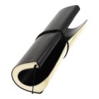 A closed, black leather-bound book with a soft cover and an elastic strap wrapped around it, slightly curled up. The pages inside appear off-white.