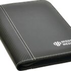 A black zippered binder with white stitching features the Mission Media logo in white on the front cover. The binder has a faux leather and fabric design, offering a sleek, professional appearance.