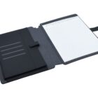 Open black leather folder with a lined notepad on the right side and several slots for cards or papers on the left. The folder has a strap closure and is placed on a white surface.