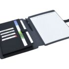 An open black leather portfolio with a lined notepad on the right. The left side has slots holding cards and a blue pen. The interior is organized and sleek, suitable for meetings or notes.