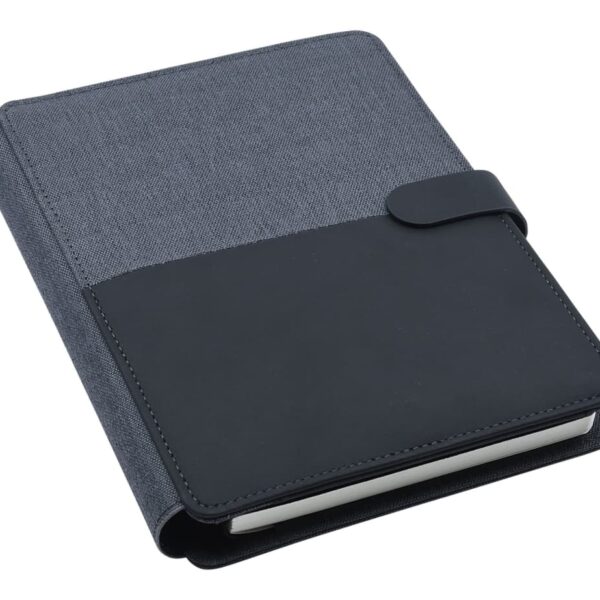 A closed, hardcover notebook with a gray fabric cover and a black leather-like band across the middle. It features a strap closure on the right side. The notebook has a simple, elegant design.
