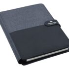 A closed fabric-covered notebook with a black faux leather flap and a magnetic closure. The closure is labeled Hindmarsh Collection. The notebook has a modern, professional appearance.
