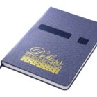 A closed blue notebook with a textured cover featuring yellow printed text: Pelpas - The Premier Option. The notebook has an attached blue ribbon bookmark.