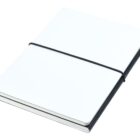 A closed, white notebook with a black cover, secured by a black elastic band, resting on a white surface.