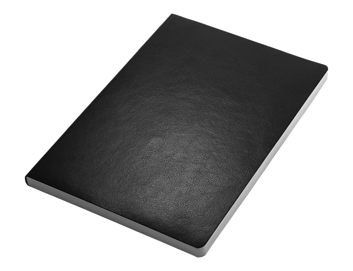 A closed black leather-bound notebook lies on a plain white background, showing its textured cover and neatly aligned edges.