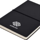 A black notebook with a white geometric logo and the word AUSGLASS on the cover. It is secured with a black elastic band and has a ribbon bookmark.