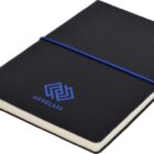 A black notebook with a blue elastic band around it, featuring the AUSGLASS logo in blue on the cover. The notebook is positioned at an angle, showing its spine and part of the front cover.