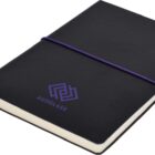 A black notebook with AUSGLASS and a geometric logo in purple on the cover. It is secured with a purple elastic band and has a black ribbon bookmark. The notebook is closed and positioned on a white background.